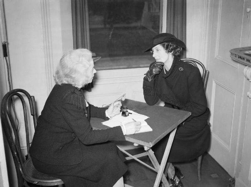 A widow of a civil servant seeks advice about her delayed pension from volunteer Mrs Wraight at the Citizens' Advice Bureau in Croydon. Mrs Wraight was one of 12 volunteers working at the bureau at this time. © IWM (D 522)